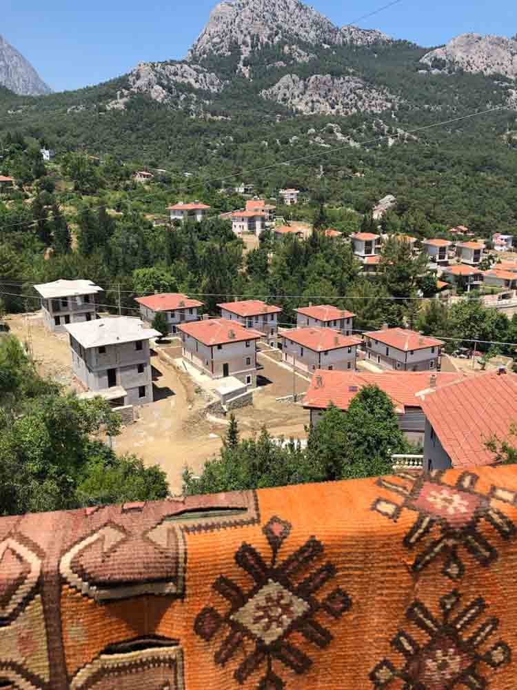 Mountain Countryside of Antalya With Rugs Over Balcony